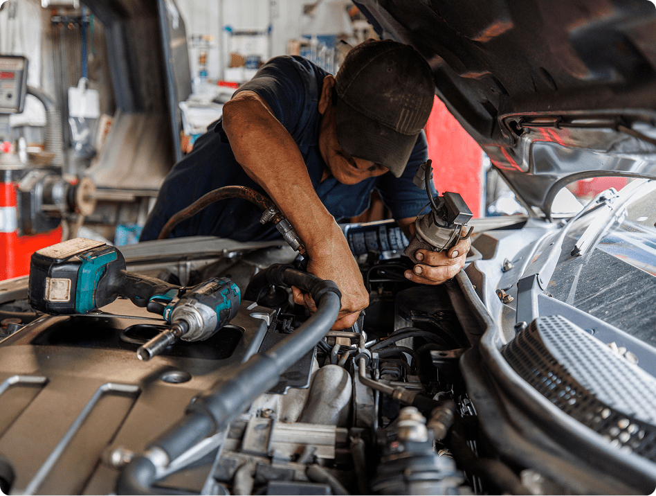 Technician fixing vehicle engine