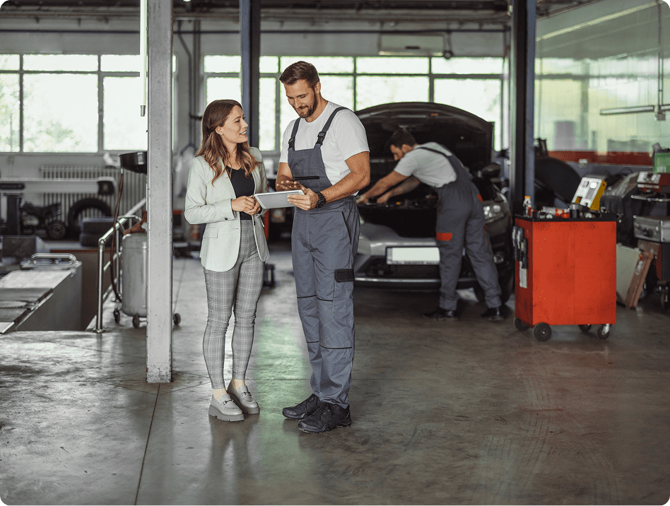 Mechanics discussing car repairs in garage